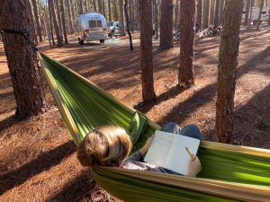 Child in hammock with Vintage Airstream at Aiken State Park